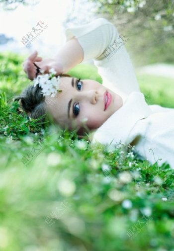 躺在绿草地上的清纯快乐美女图片