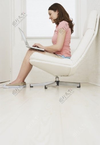 转椅上玩电脑的漂亮女人图片