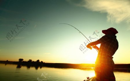 夕阳下钓鱼的男人图片
