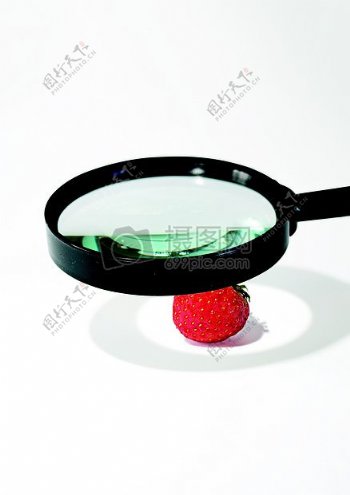 放大镜照着草莓